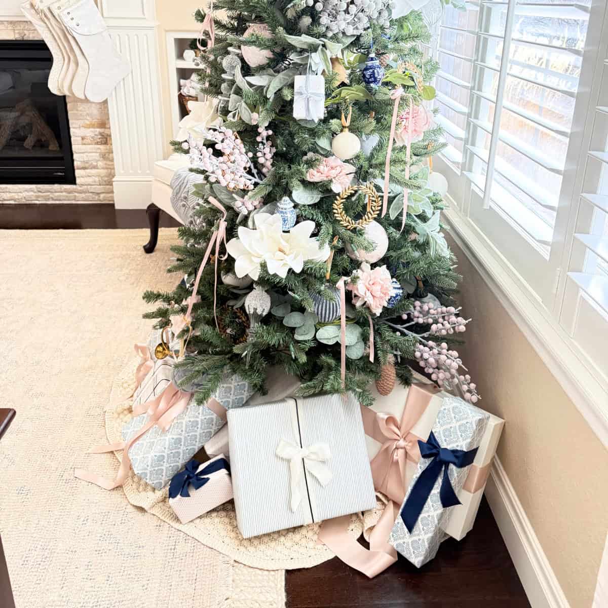 presents wrapped in blue pink and white paper under a tree