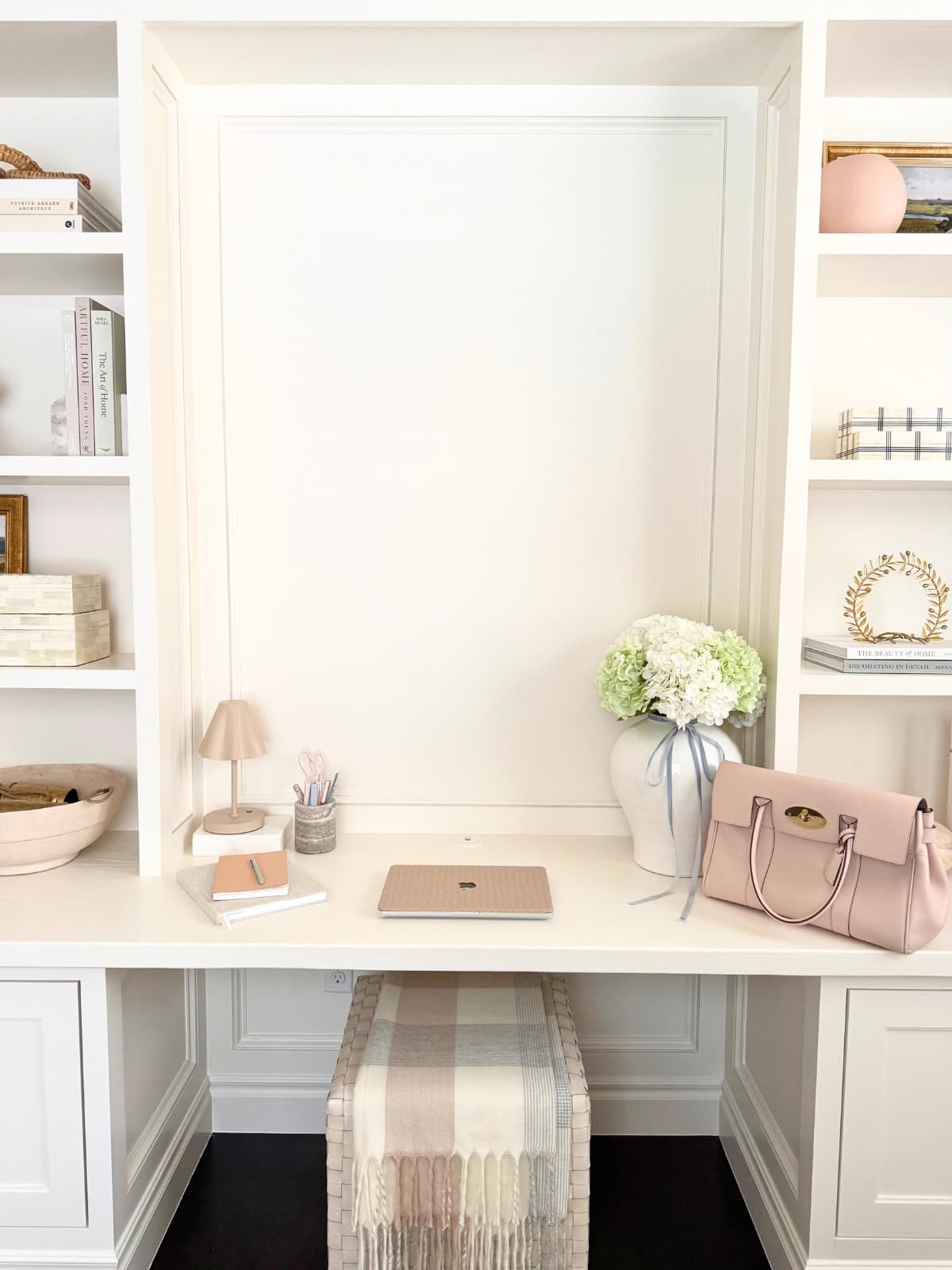 white built-in desk flanked by shelves