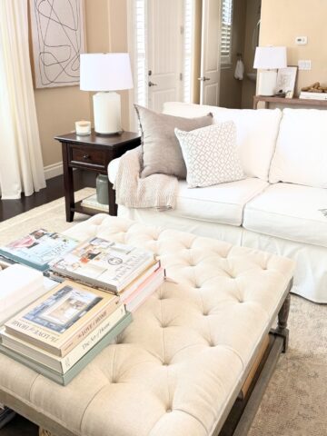linen tufted ottoman with white sofa in living room