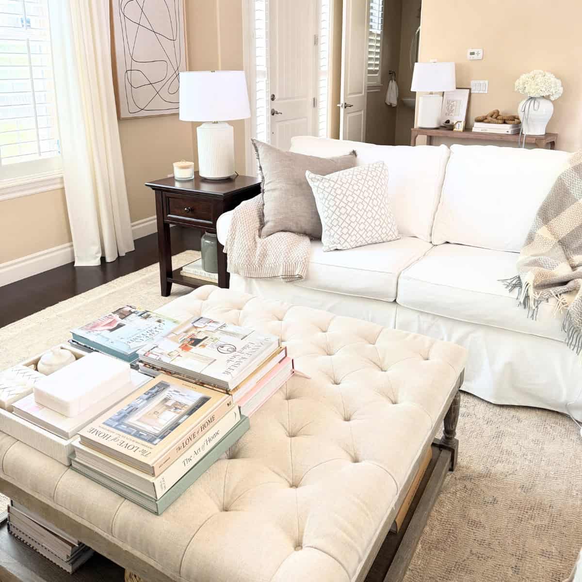 linen tufted ottoman with white sofa in living room