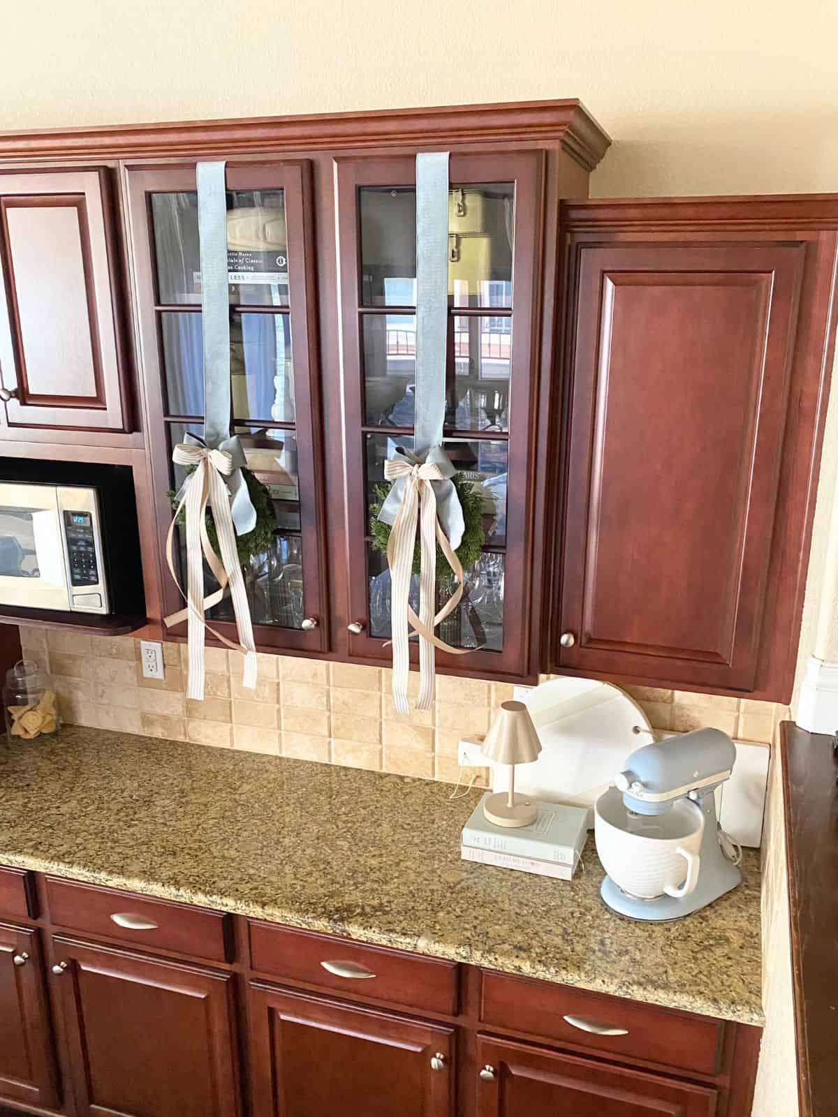 kitchen cabinets with wreaths hanging