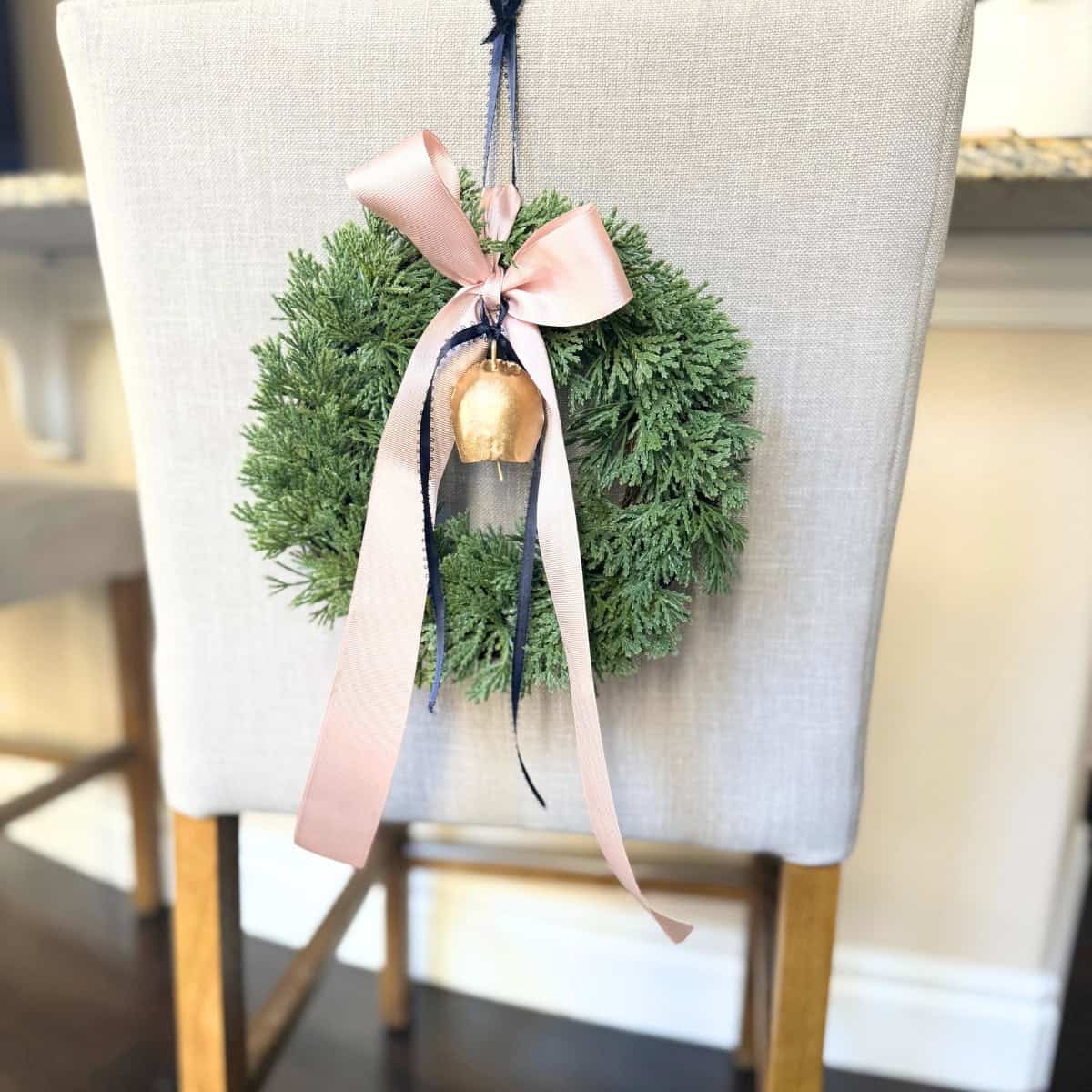 mini wreath on island chair with ribbons and a bell