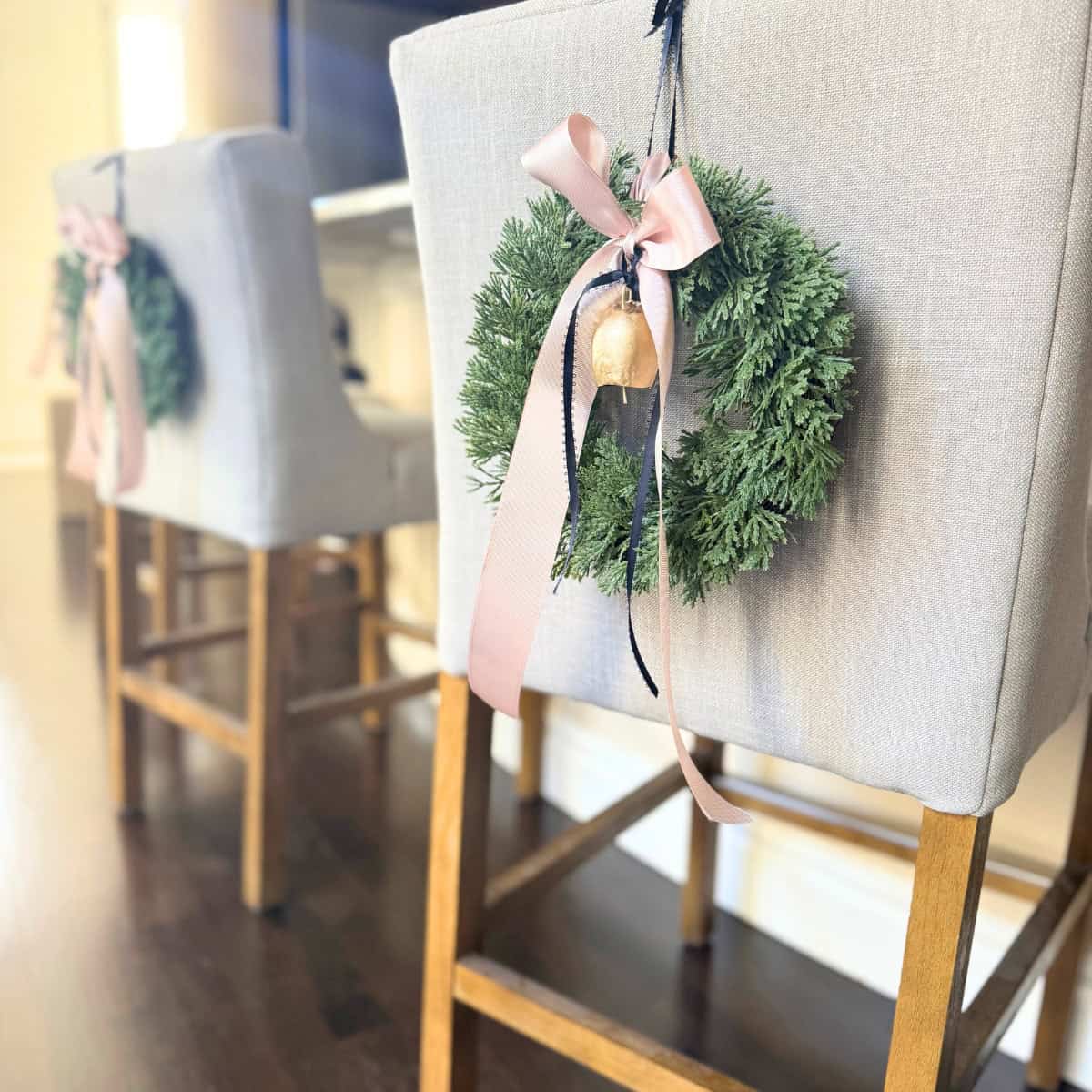 mini wreath on island chair with ribbons and a bell
