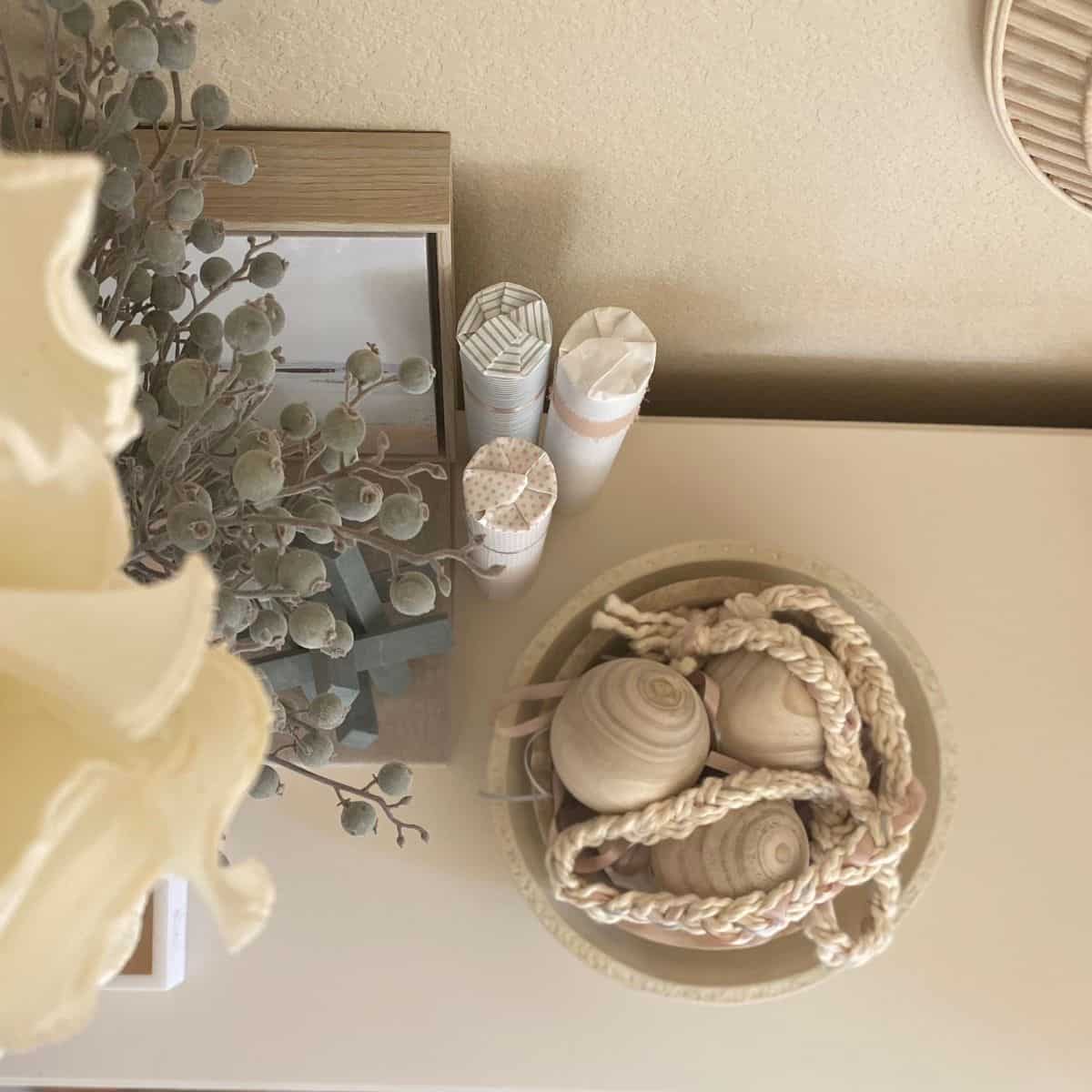 braided yarn garland with ribbon in a wood bowl